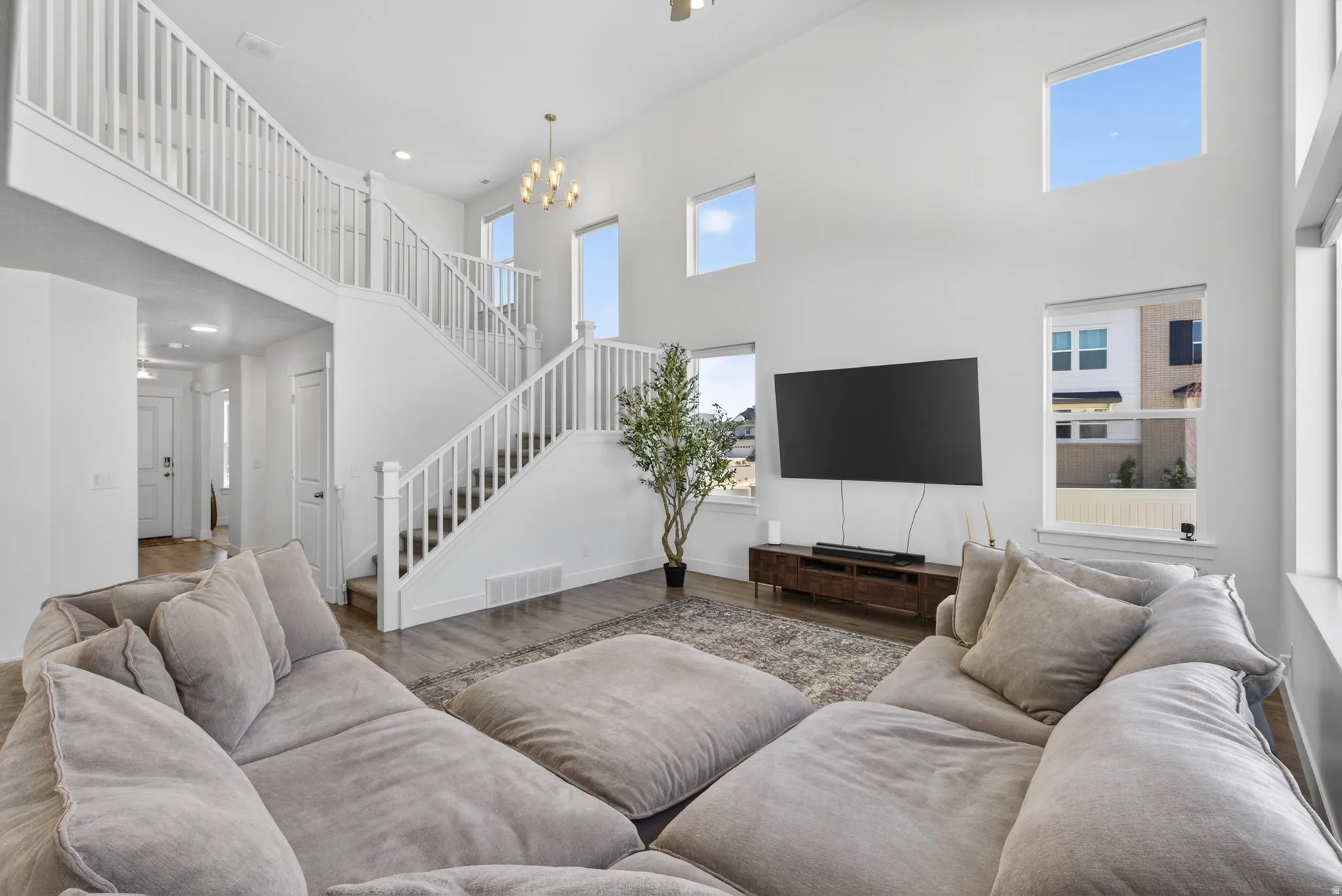 Two-story living area featuring high ceilings and multiple windows