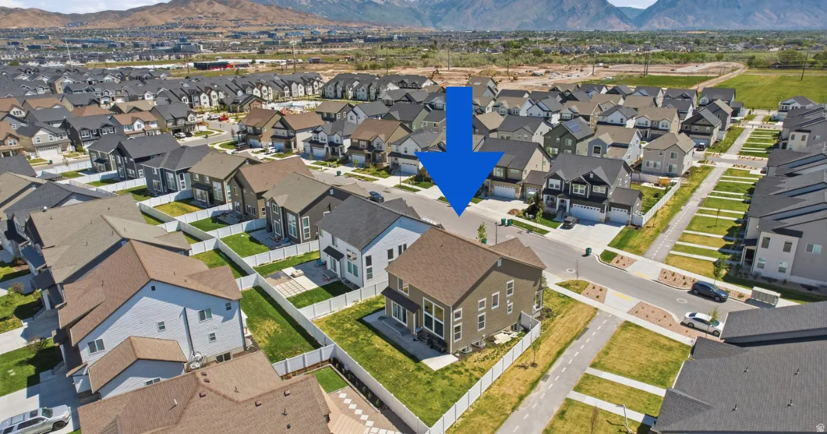 Contemporary residential development featuring a neutral-toned two-story home with a tan roof