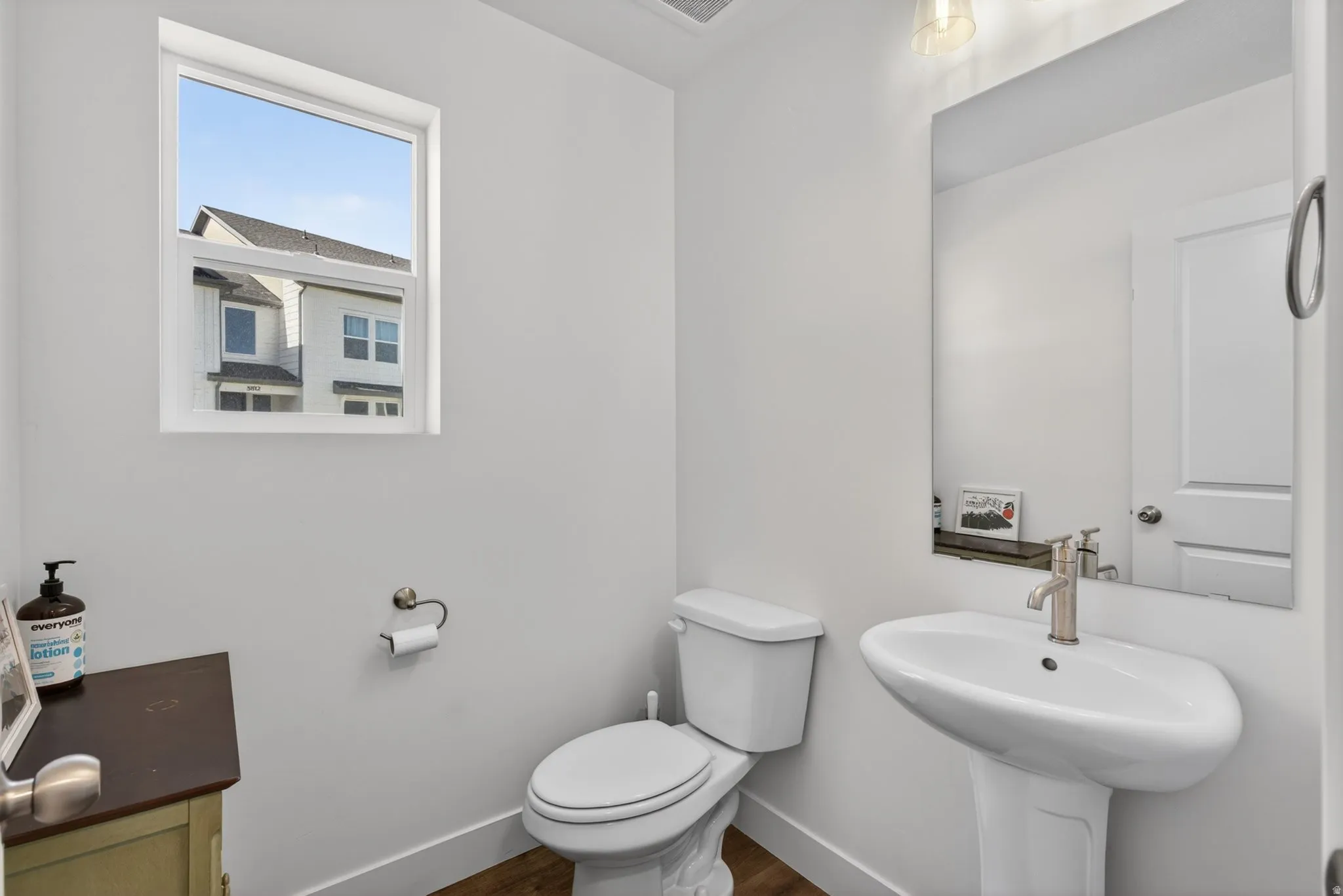 1/2 bathroom, pedestal sink with brushed nickel faucet, large wall mirror