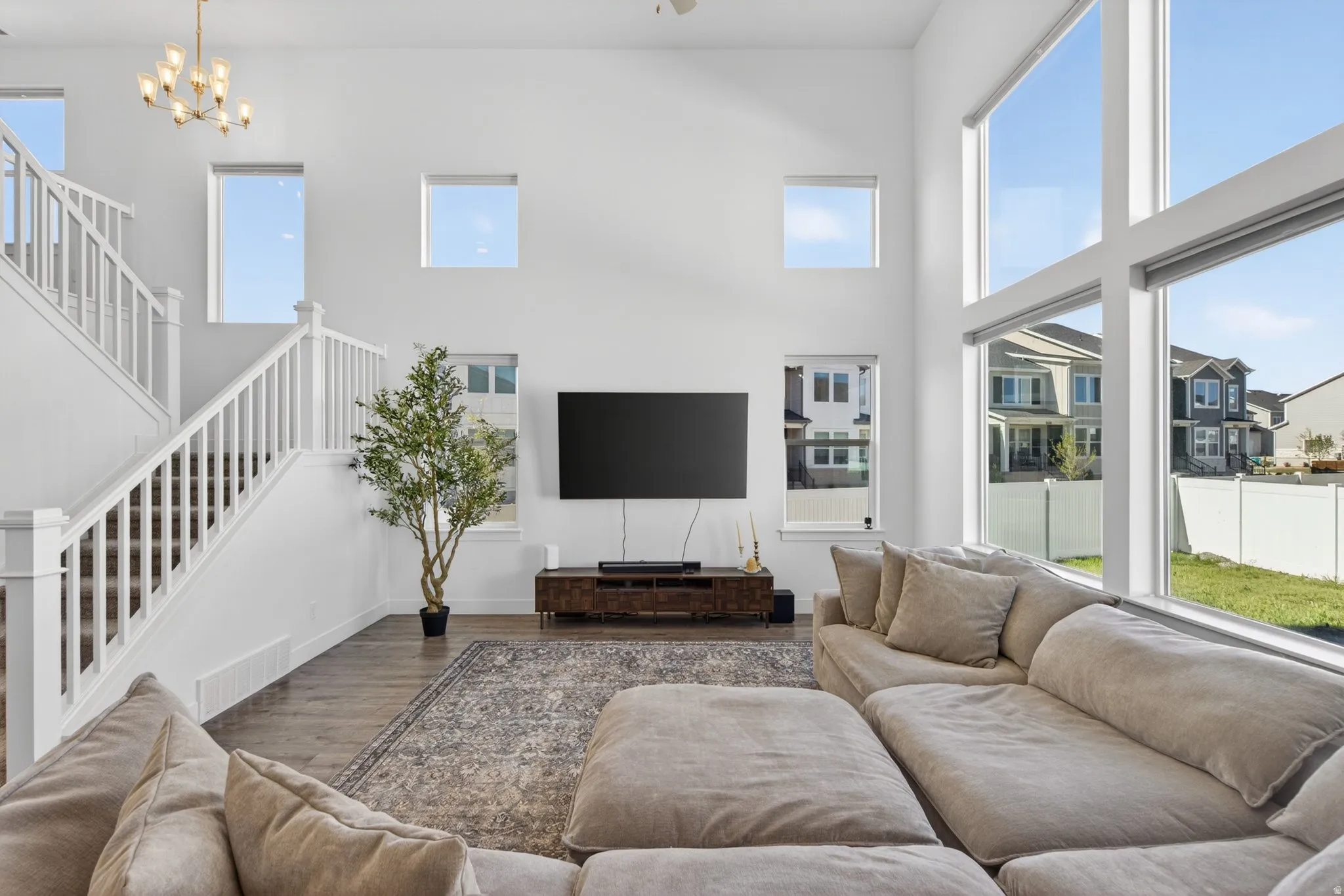 Open-concept living space featuring soaring ceilings and abundant natural light