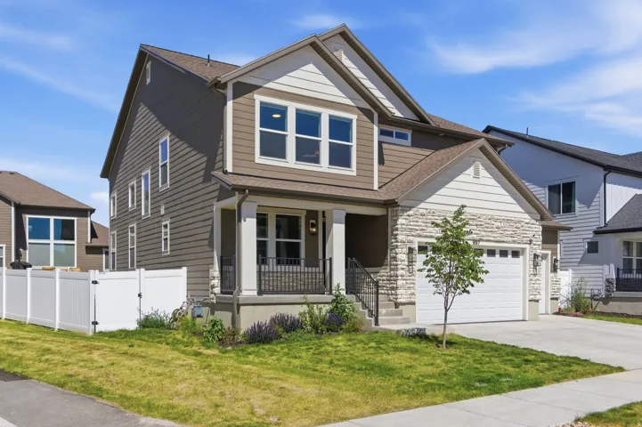 Contemporary two-story exterior featuring brown siding and white stone accents