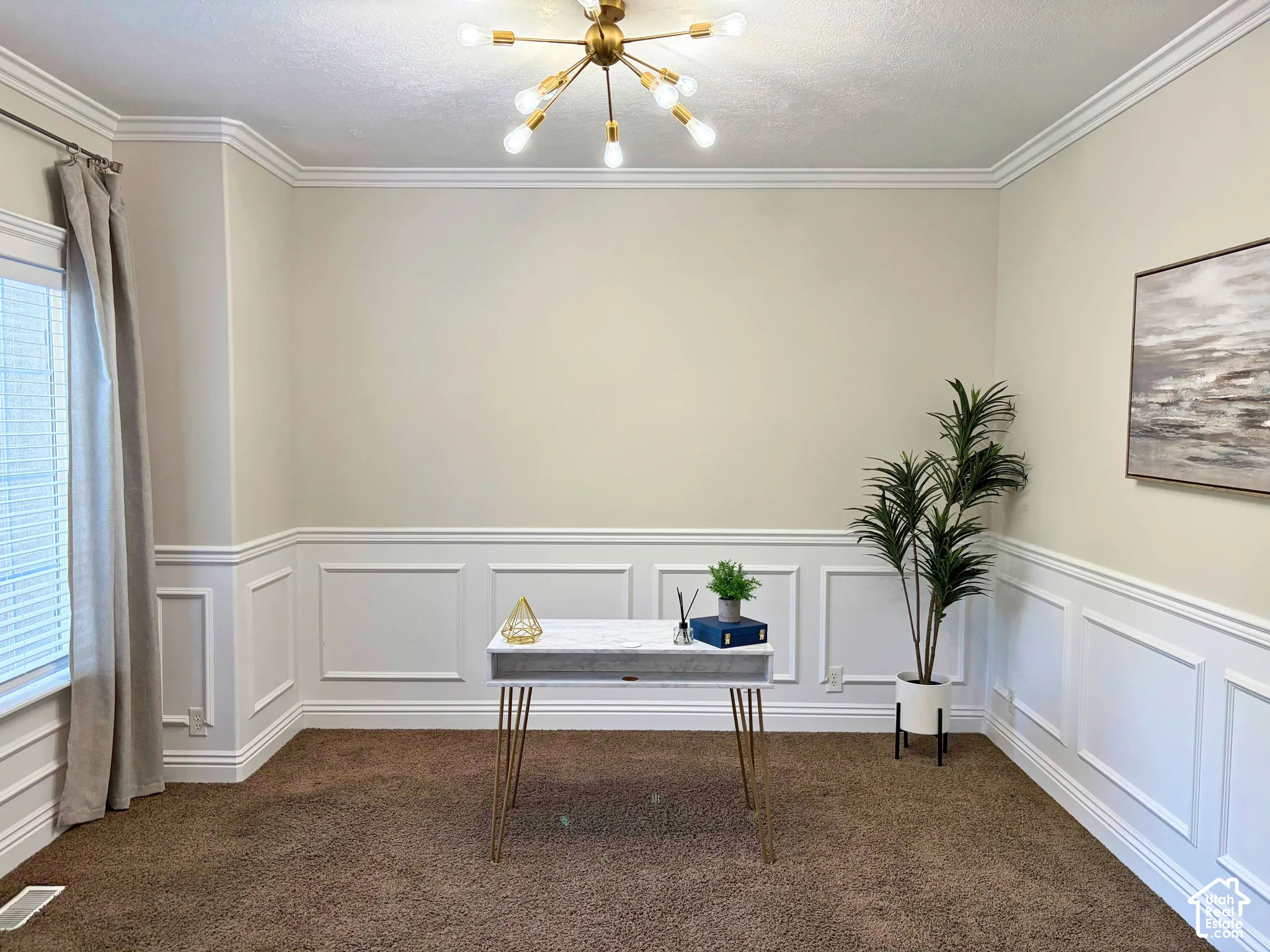 Crown molding accents the ceiling, complemented by wainscoting paneling