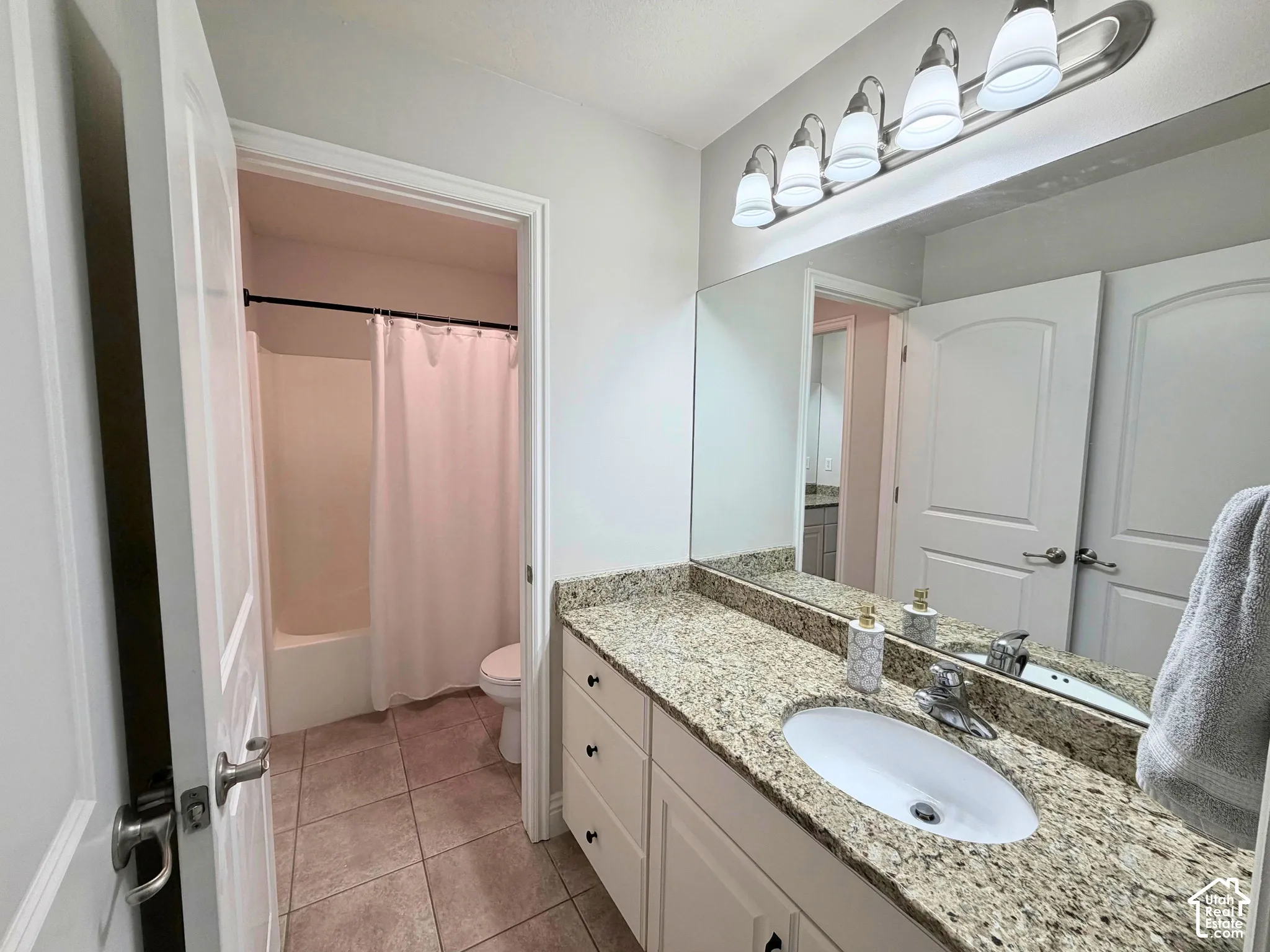 Vanity with a granite-style countertop and integrated sink