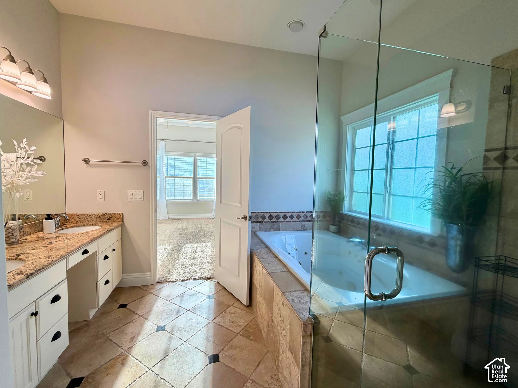Dual vanity with stone countertops and undermount sinks