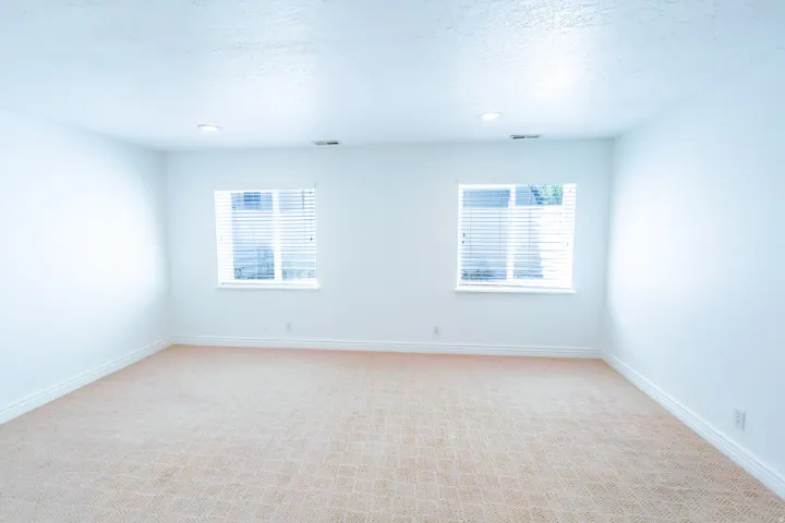 Room featuring neutral patterned carpeting and white walls