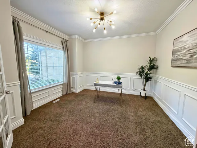 Crown molding and wainscoting detailing enhance the room