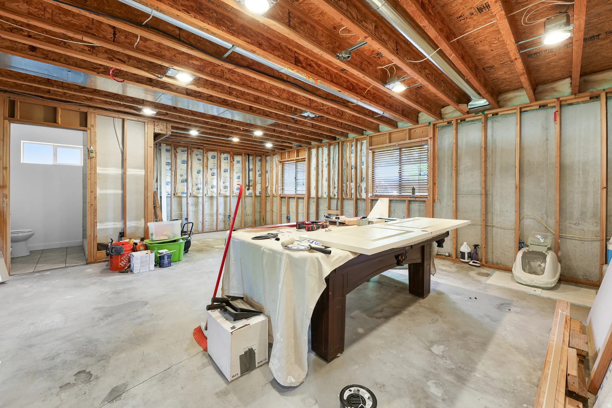 Unfinished interior space with exposed ceiling joists and concrete flooring
