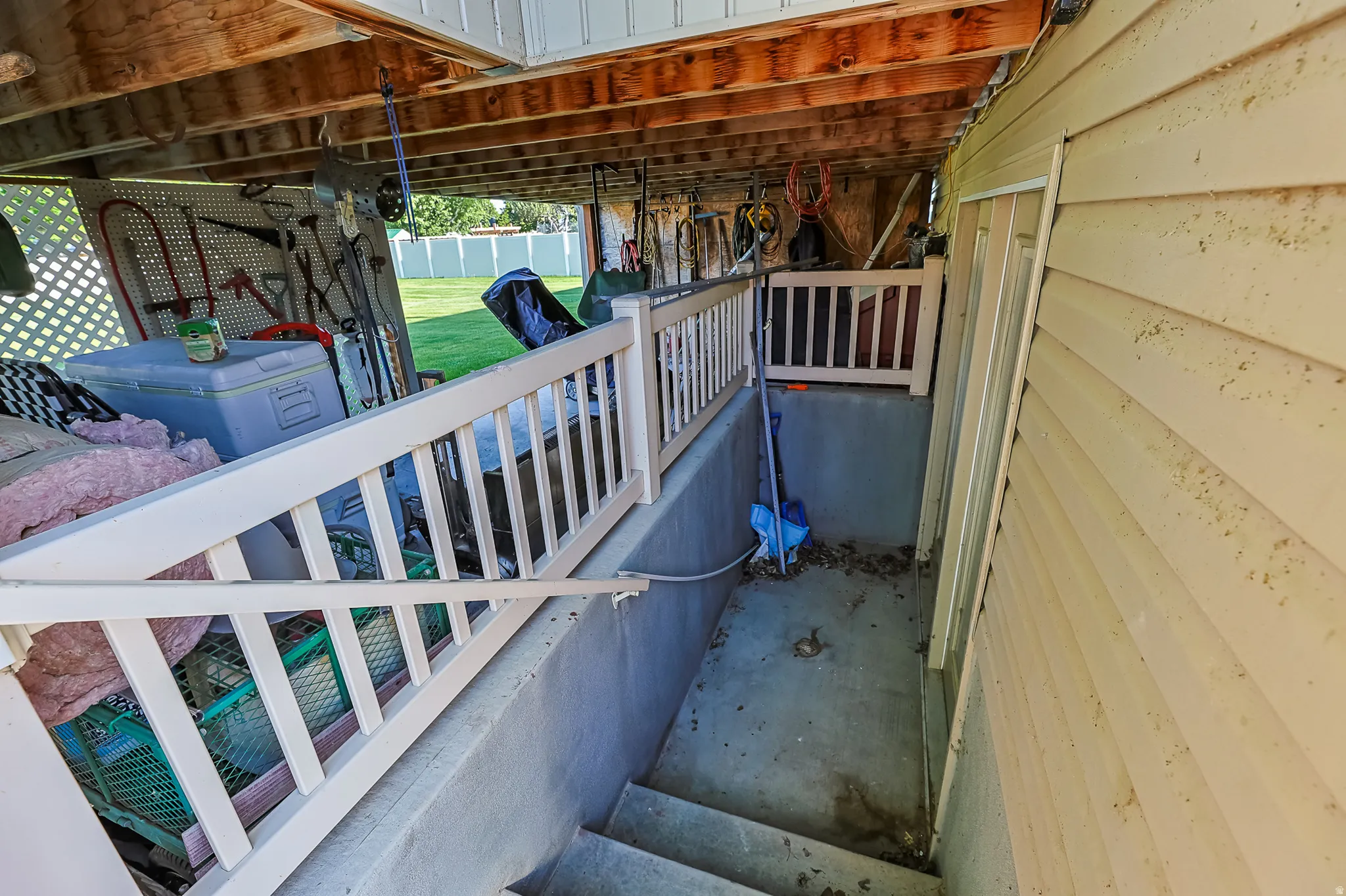 Exterior access point featuring concrete stairs and white railing