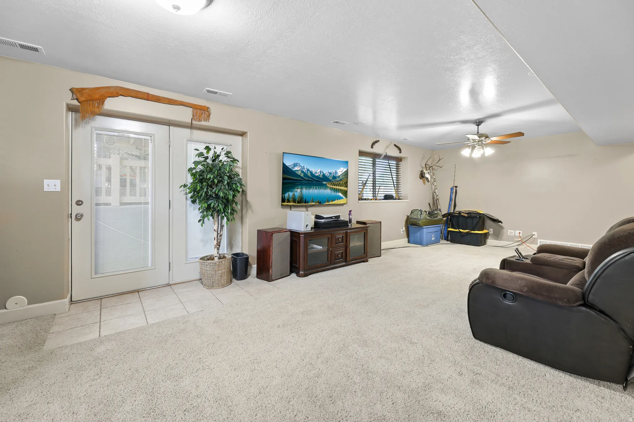 Spacious room featuring light-toned carpet flooring and neutral wall tones