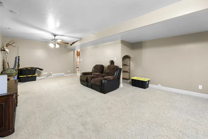 Carpeted room with recessed lighting and a ceiling fan