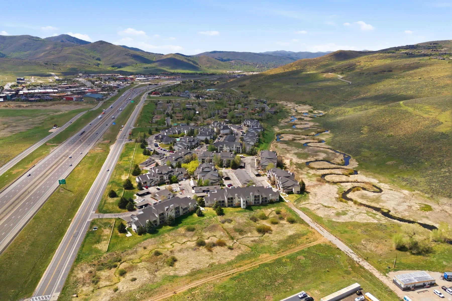 Aerial perspective highlighting a residential development with multiple buildings and ample parking