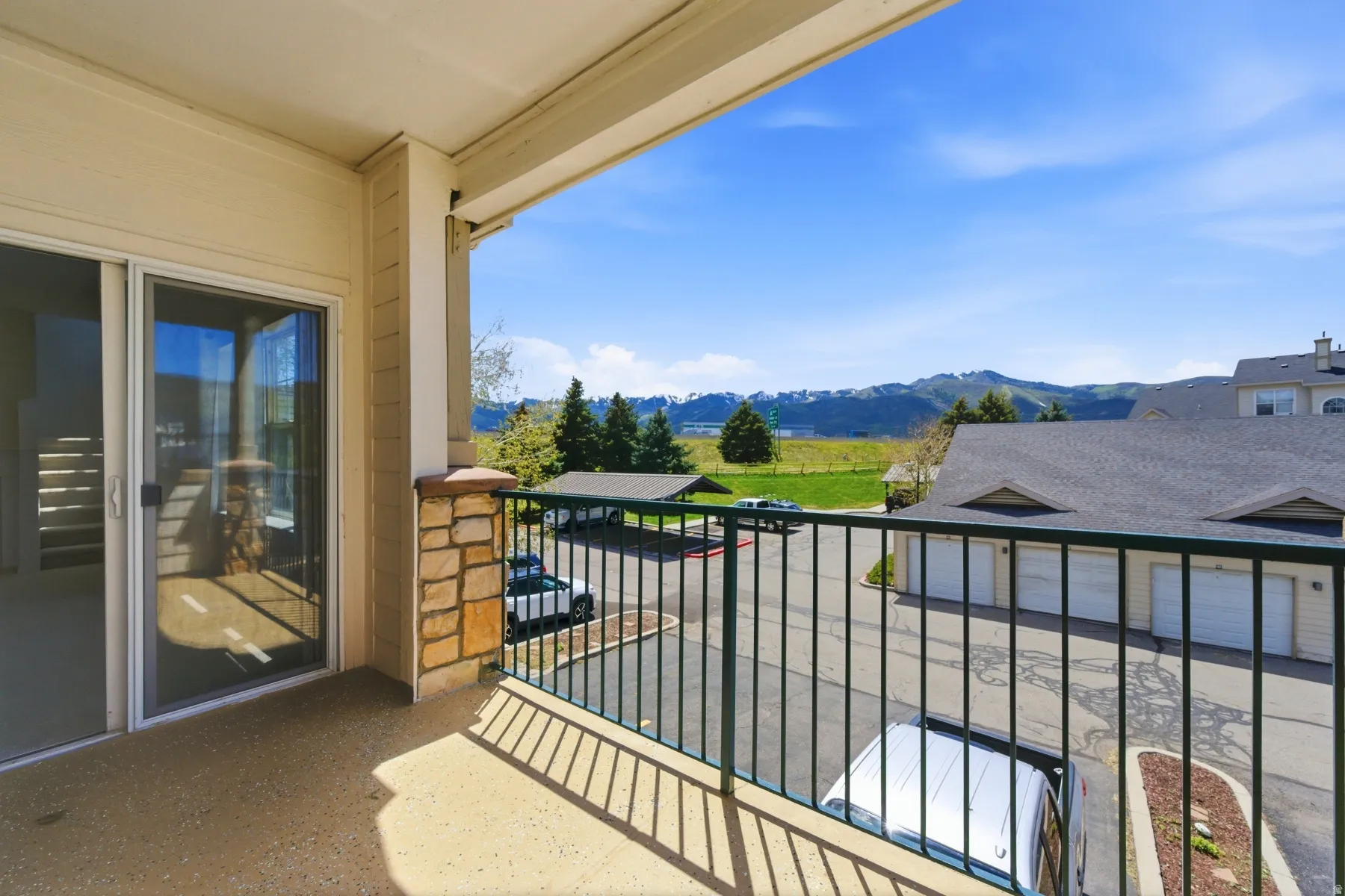 Private balcony featuring a concrete floor and a metal railing