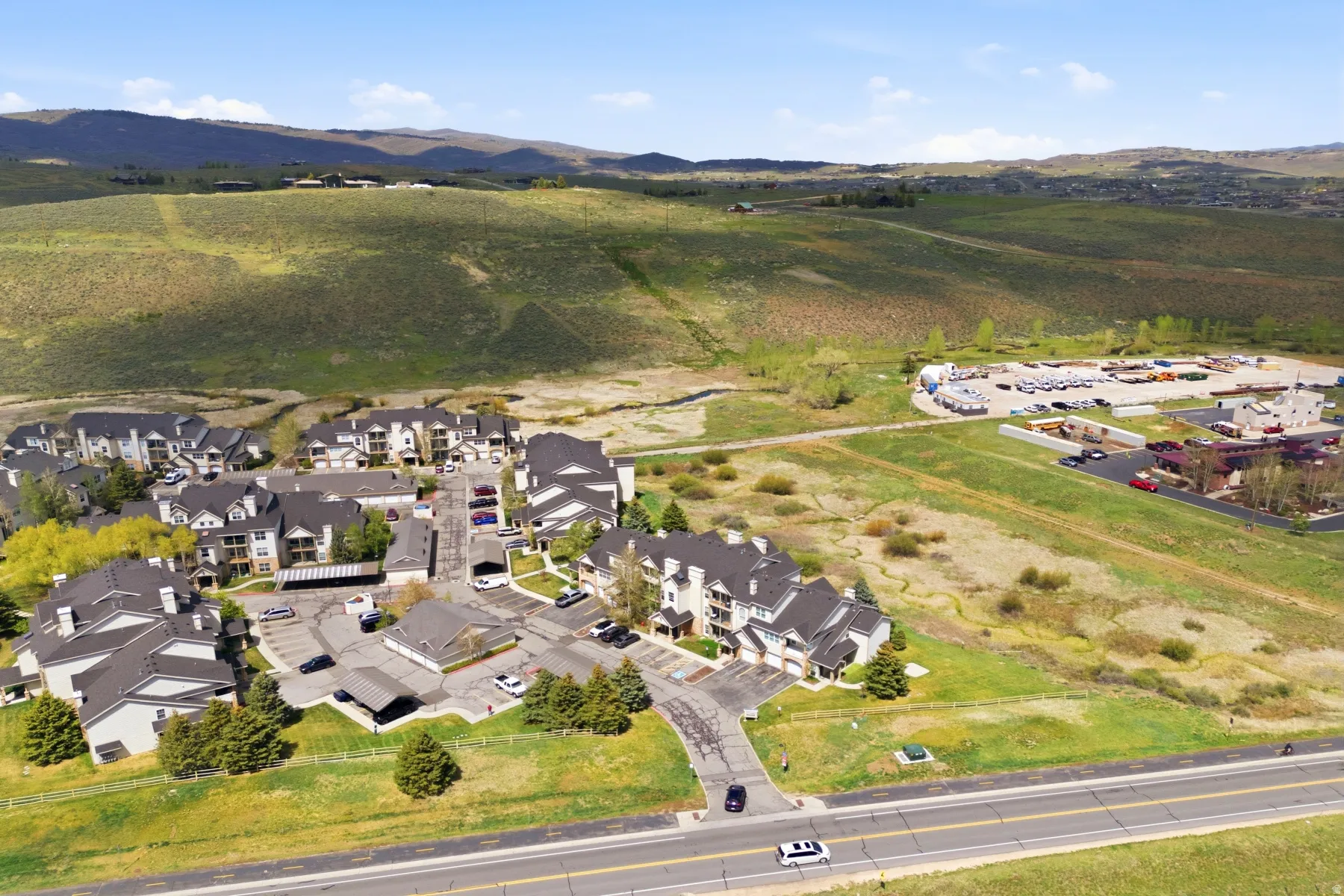 Multi-building residential complex featuring pitched roofs and multiple parking areas
