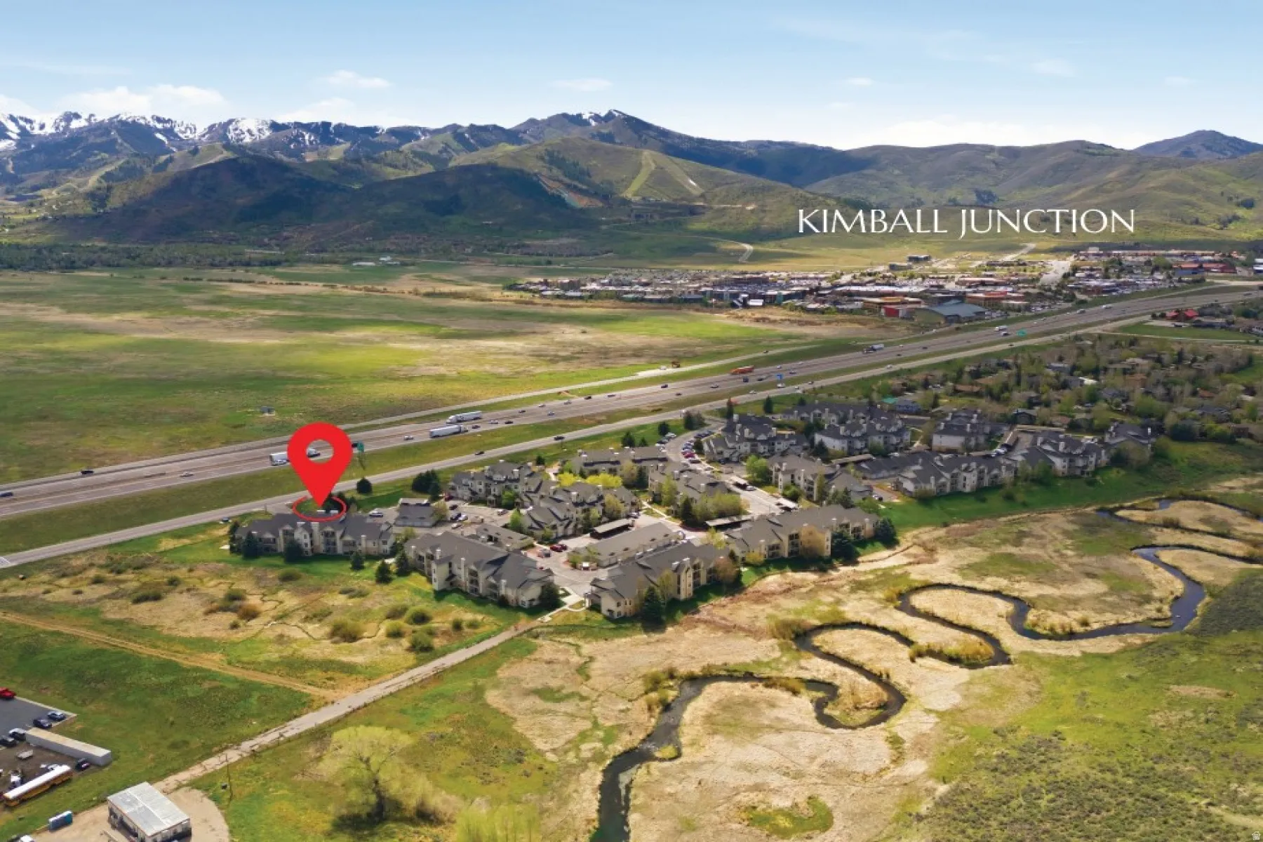 Aerial overview featuring a residential complex with direct highway frontage