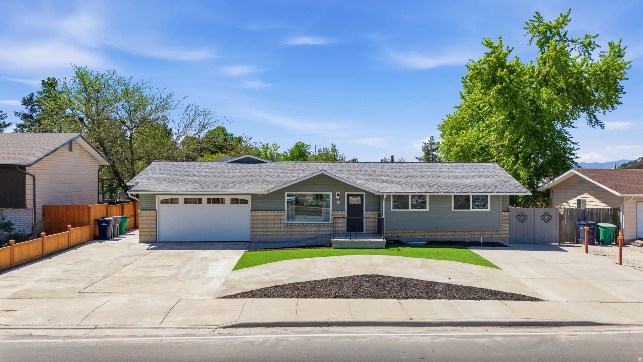 Ranch-style residence featuring a two-tone exterior with light-colored brick and horizontal siding