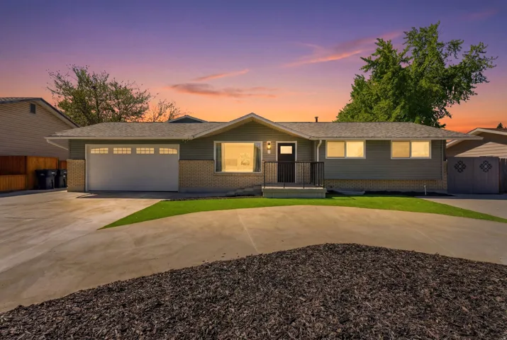 Ranch-style residence featuring horizontal siding and brick accents