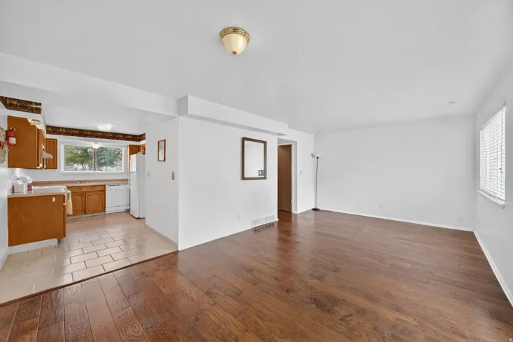 Expansive living area with rich wood-finish flooring