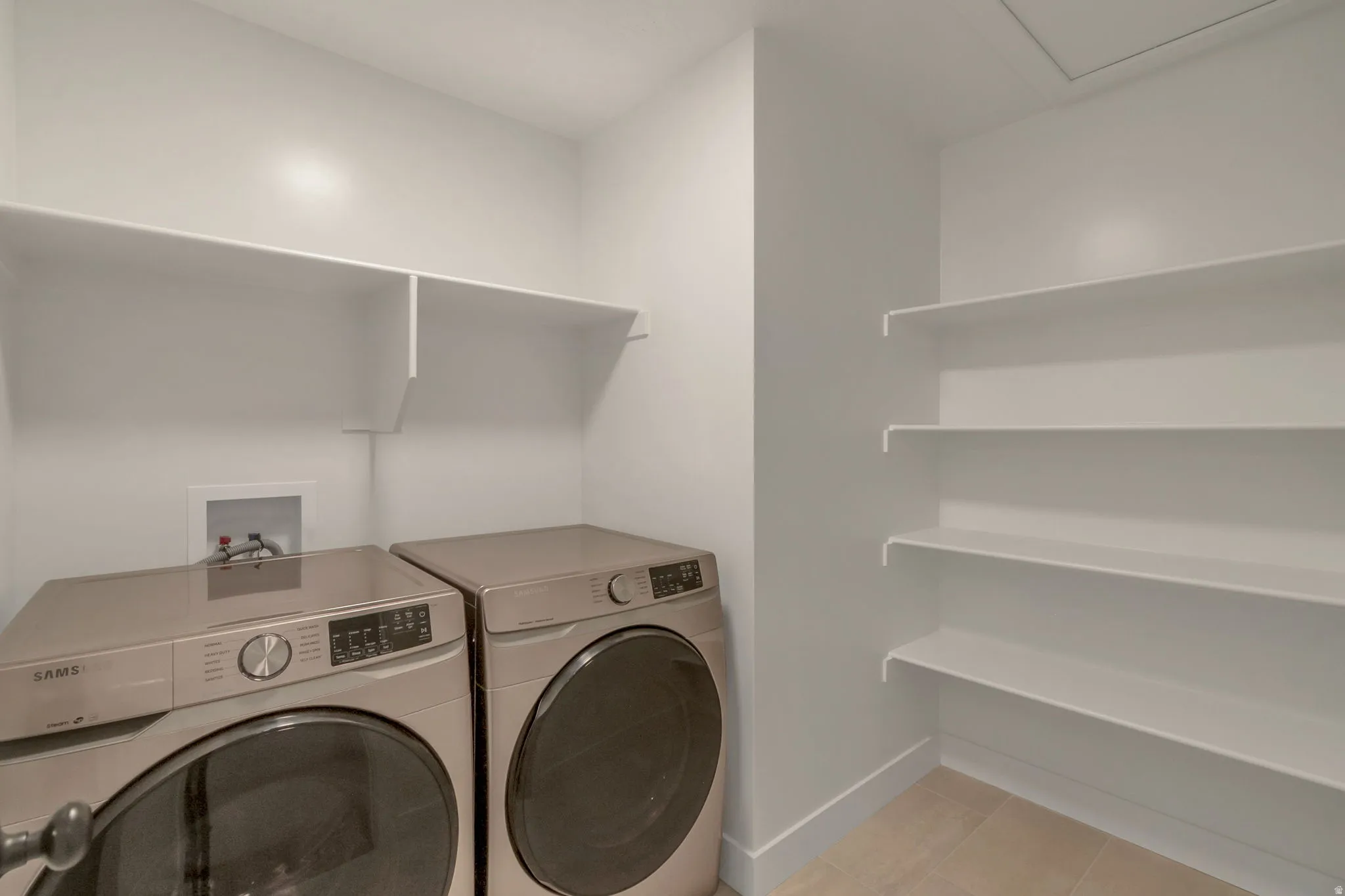 Washer/Dryer included. Dedicated utility room featuring light-toned flooring and white walls