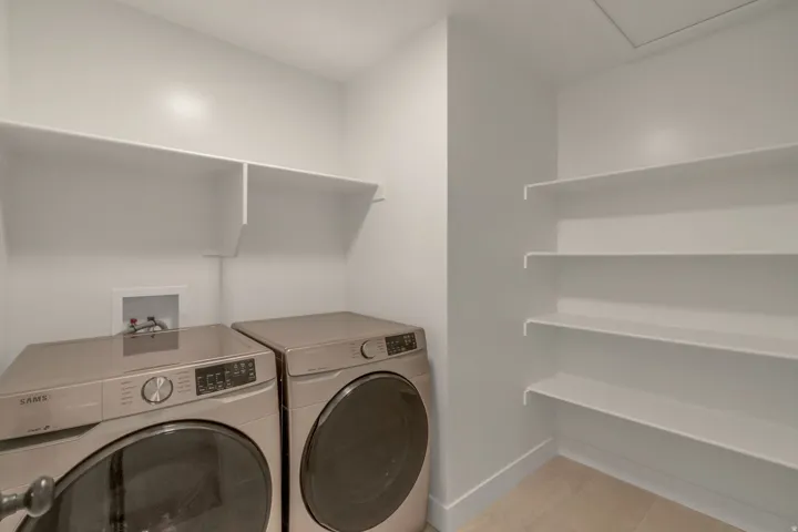 Washer/Dryer included. Dedicated utility room featuring light-toned flooring and white walls