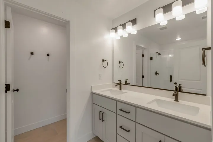 En-suite bathroom. Dual vanity with integrated sinks and white countertops