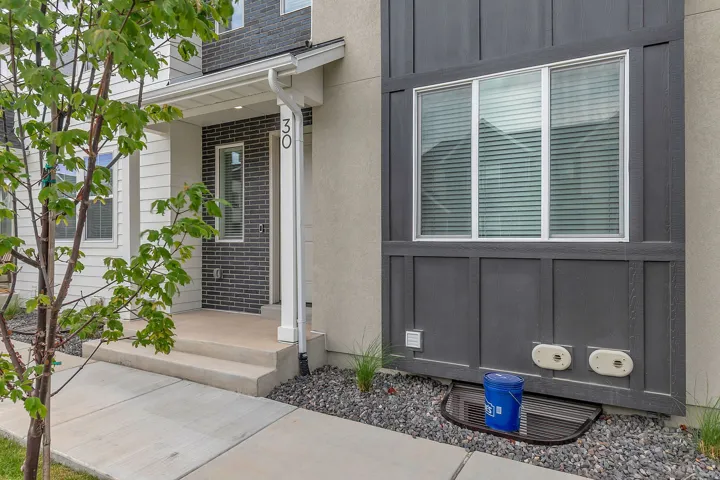 Modern exterior featuring a prominent window with horizontal blinds