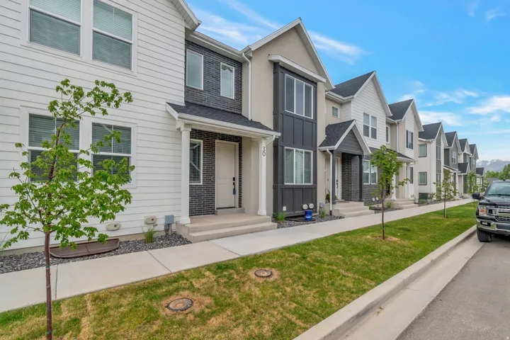 Modern townhome exterior featuring an inviting covered porch