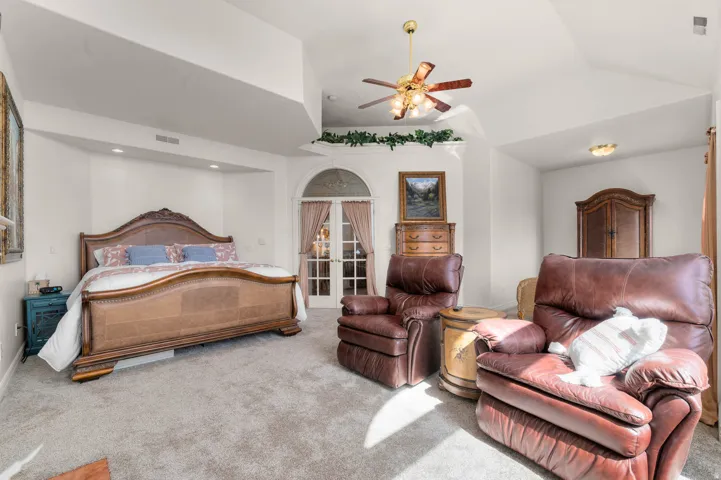 Bedroom featuring vaulted ceilings and light gray carpet
