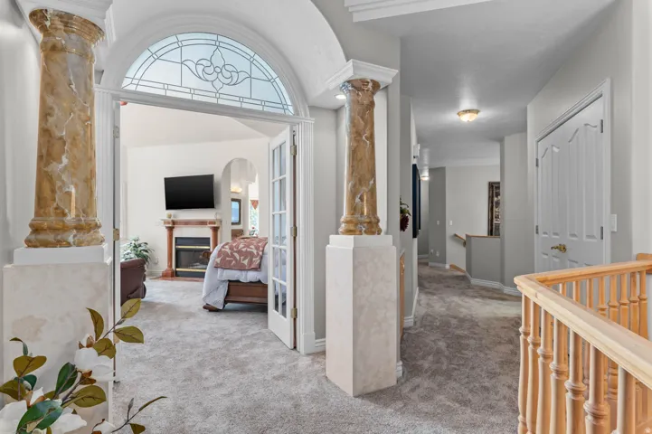 Arched entryway with stained glass transom and French doors