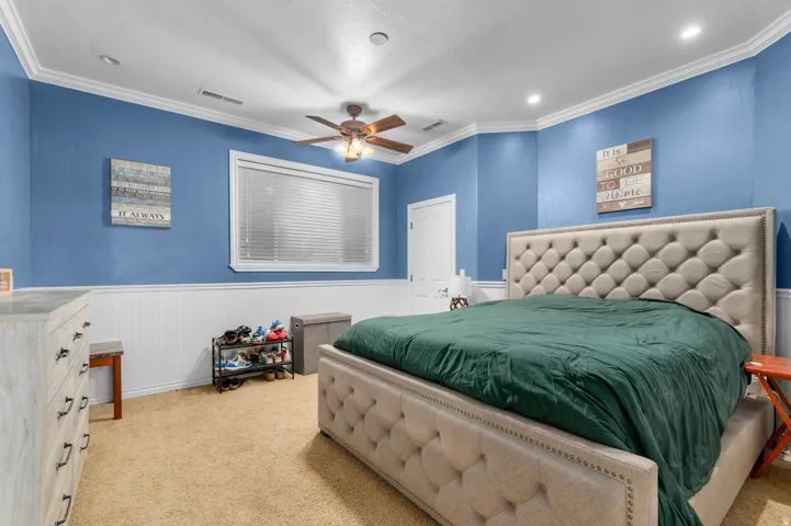 Recessed lighting and ceiling fan overhead. Large bedroom and closet.