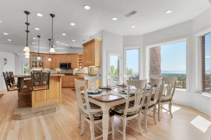 Open concept kitchen and dining area featuring light wood-finish flooring