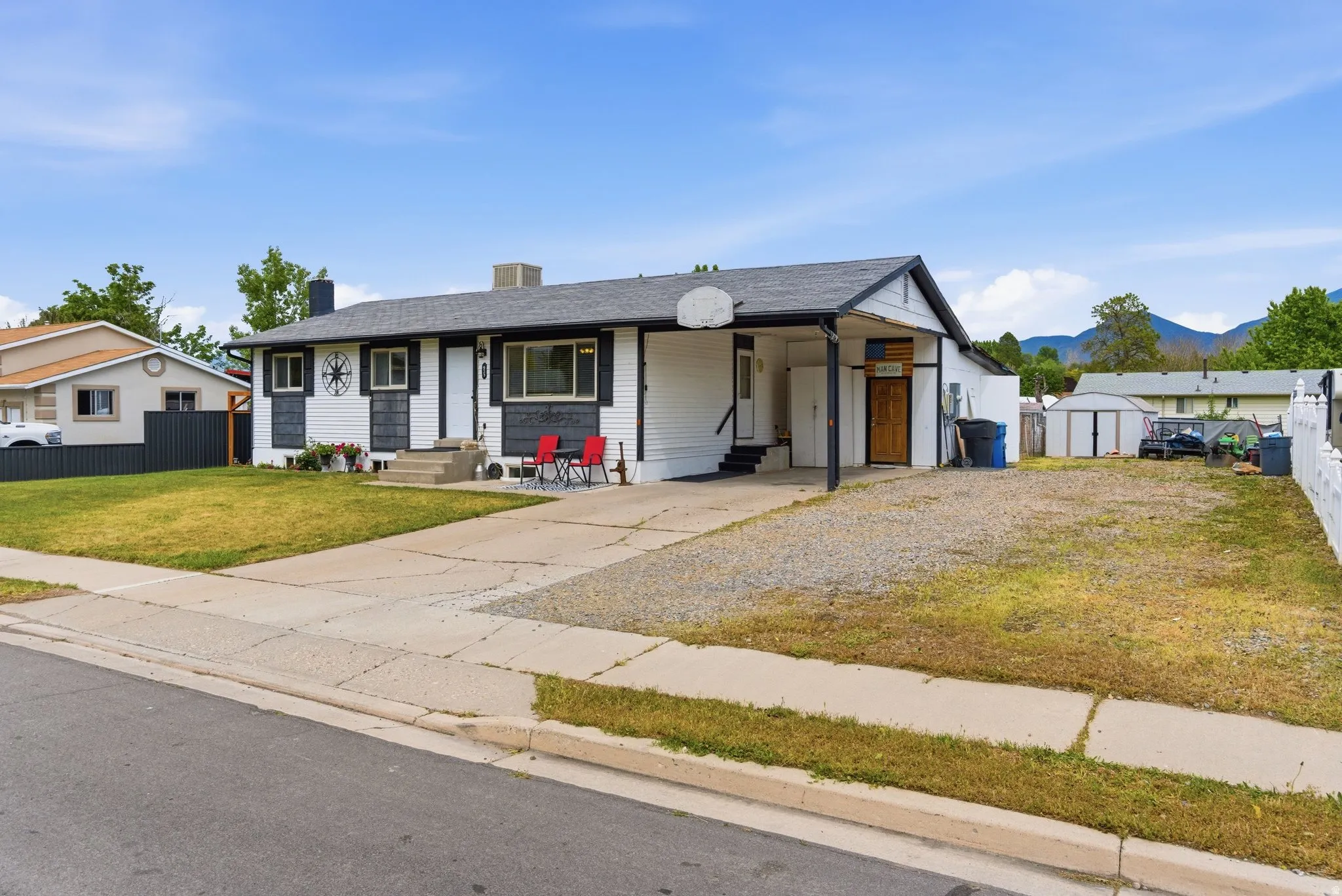 Ranch-style residence featuring a carport, and concrete driveway