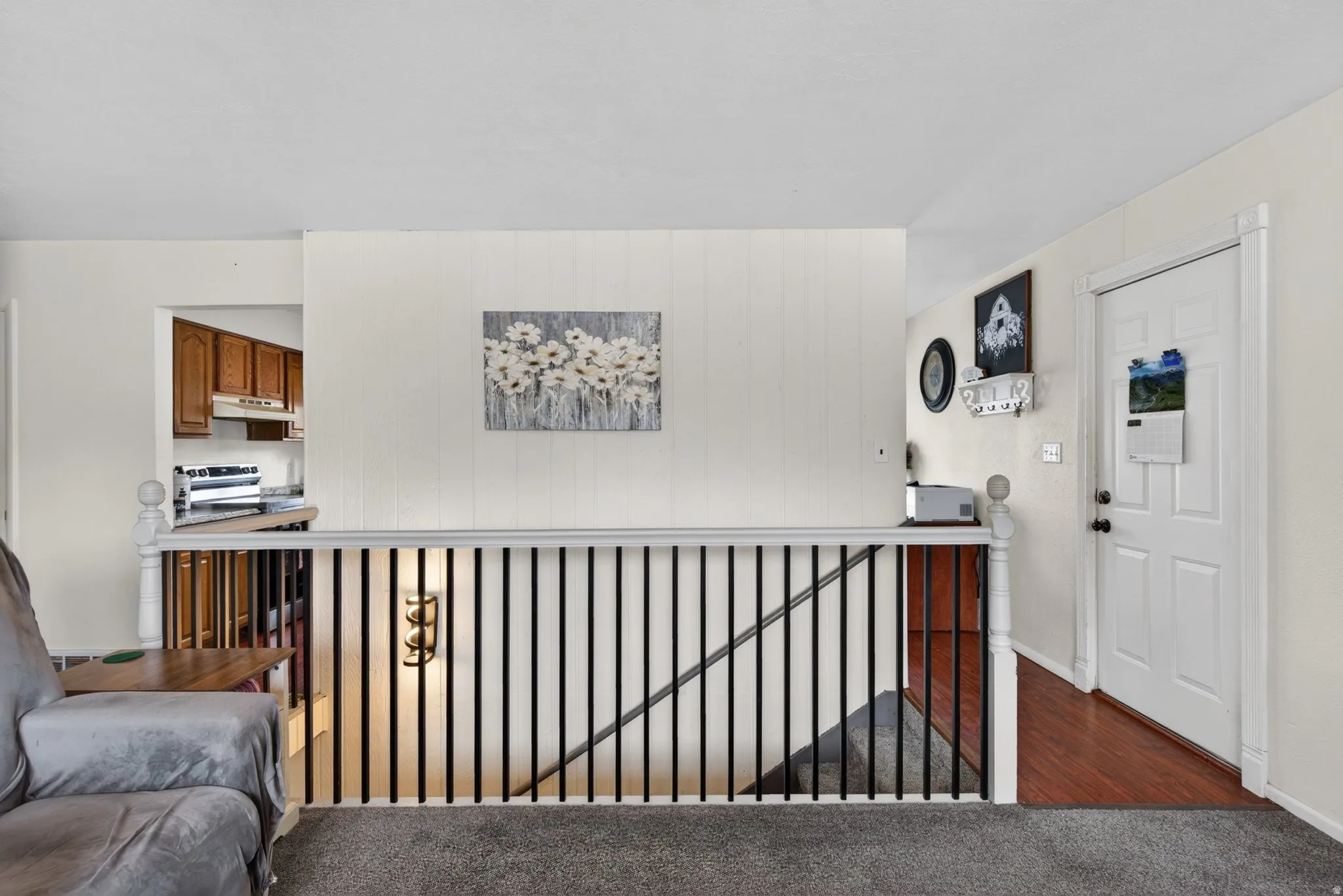 Staircase with black metal spindles and white wooden handrails