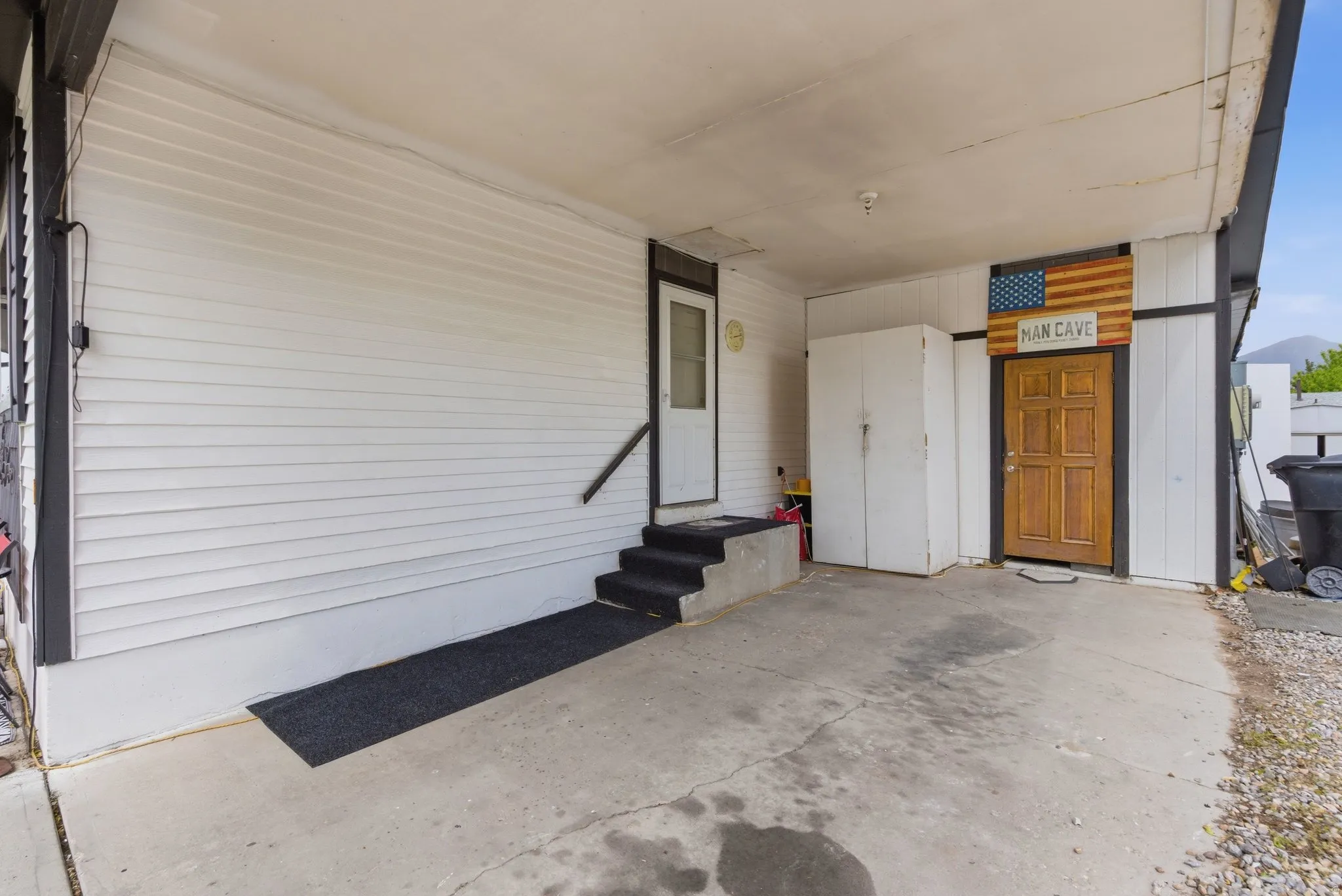 Covered concrete carport offering sheltered parking