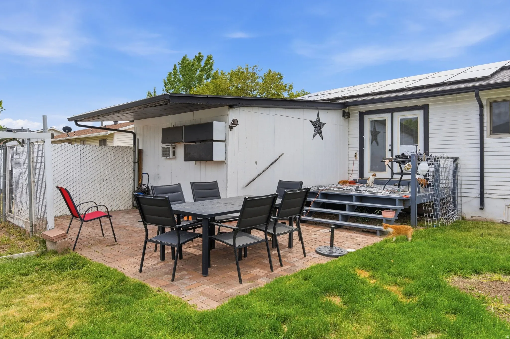 Brick paver patio with a covered extension, providing outdoor living space
