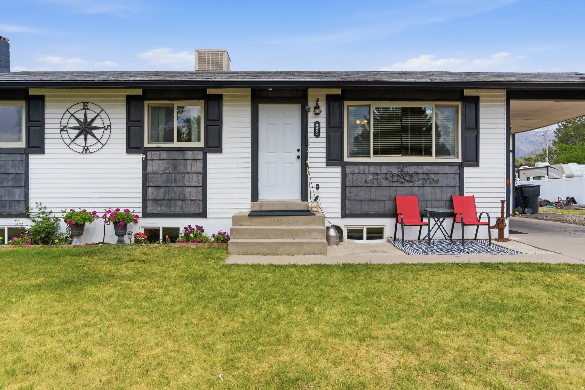 White siding exterior with dark trim and shutters