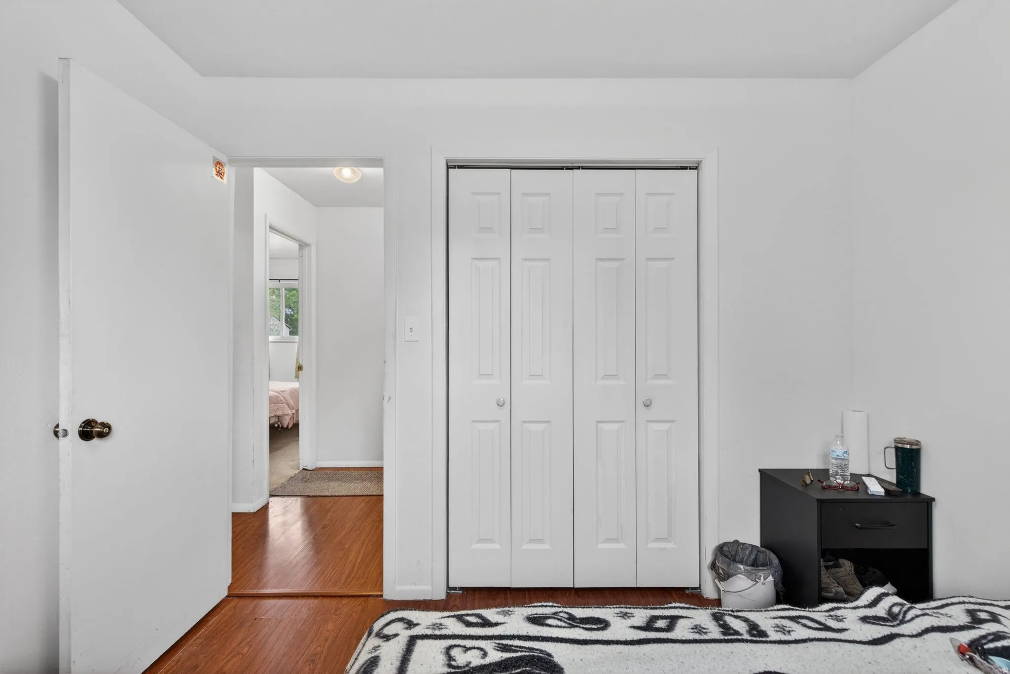 White interior walls with wood-finish flooring