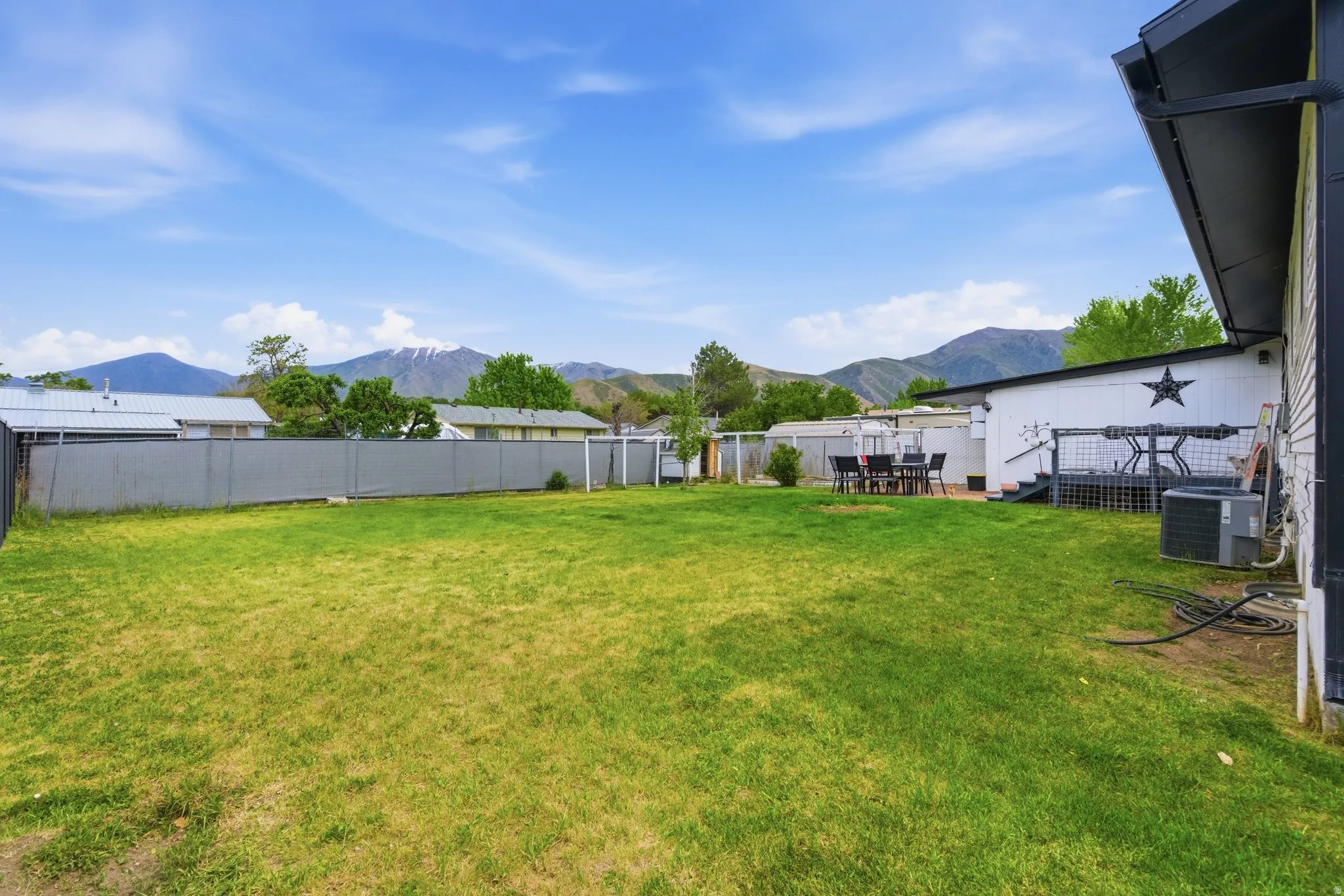 Expansive green lawn with a perimeter fence