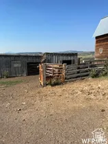 Ranch property featuring wood-sided barns and corrals