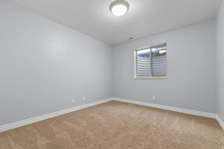 Neutral-toned carpeting paired with light-colored walls and white baseboards