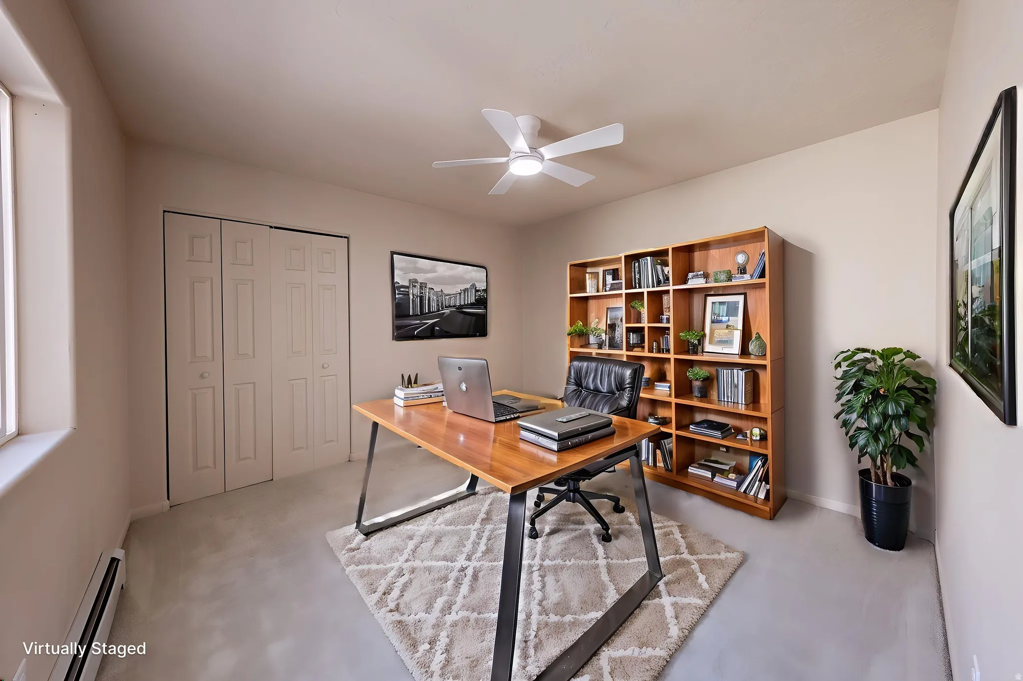 Carpeted room featuring a ceiling fan with light, baseboard heating, a window, and bifold closet doors