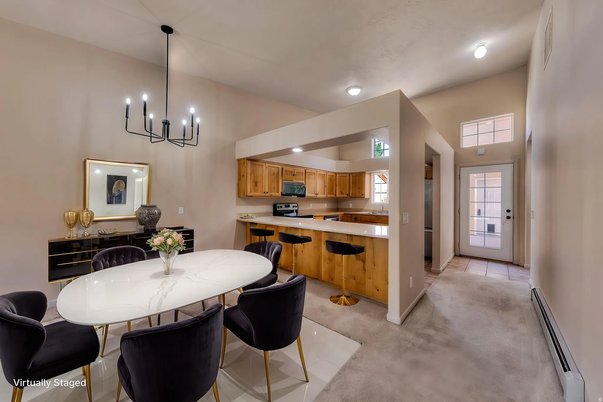 Dining area featuring a vaulted ceiling and a black chandelier