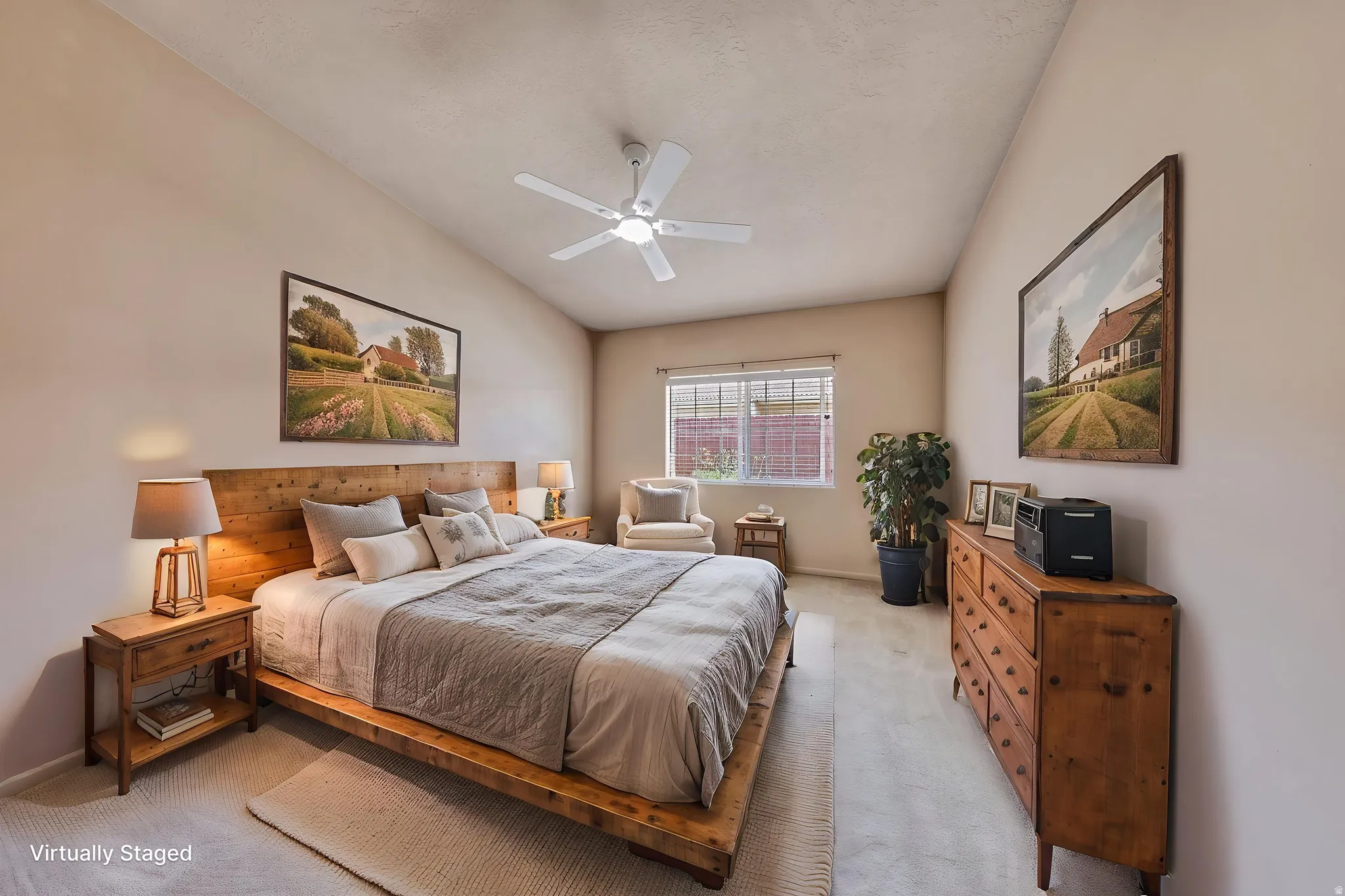 Spacious bedroom featuring vaulted ceilings, a ceiling fan, and carpet flooring