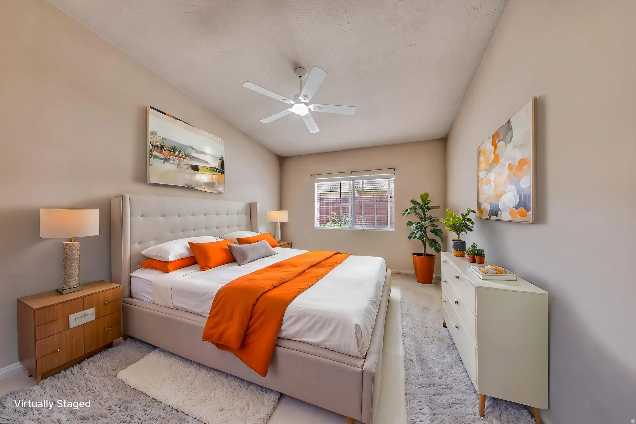 Spacious room featuring a vaulted ceiling and a ceiling fan
