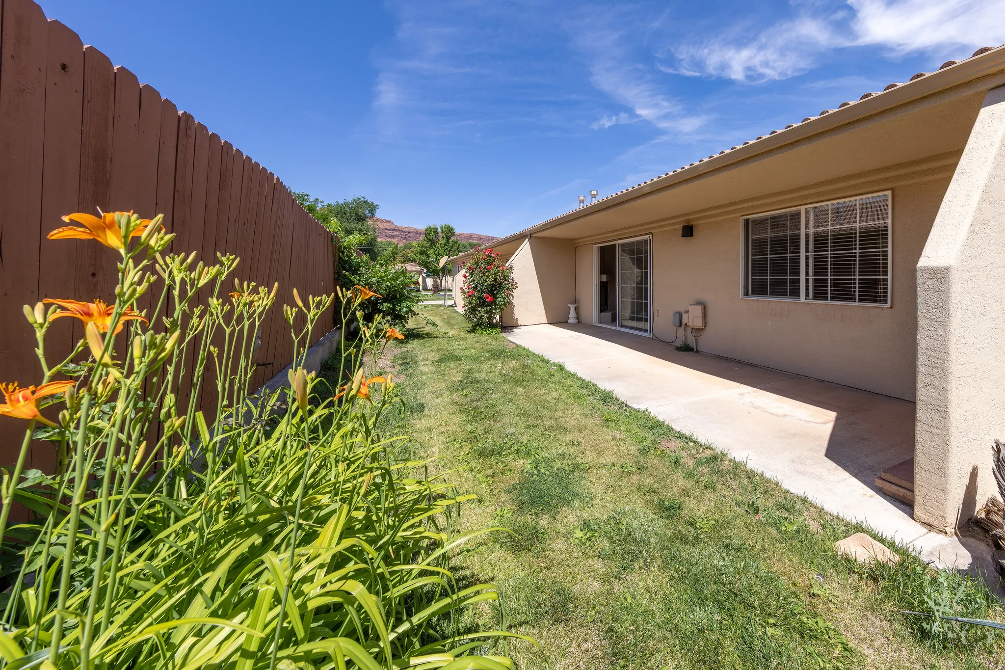 Expansive concrete patio with direct access via a glass sliding door
