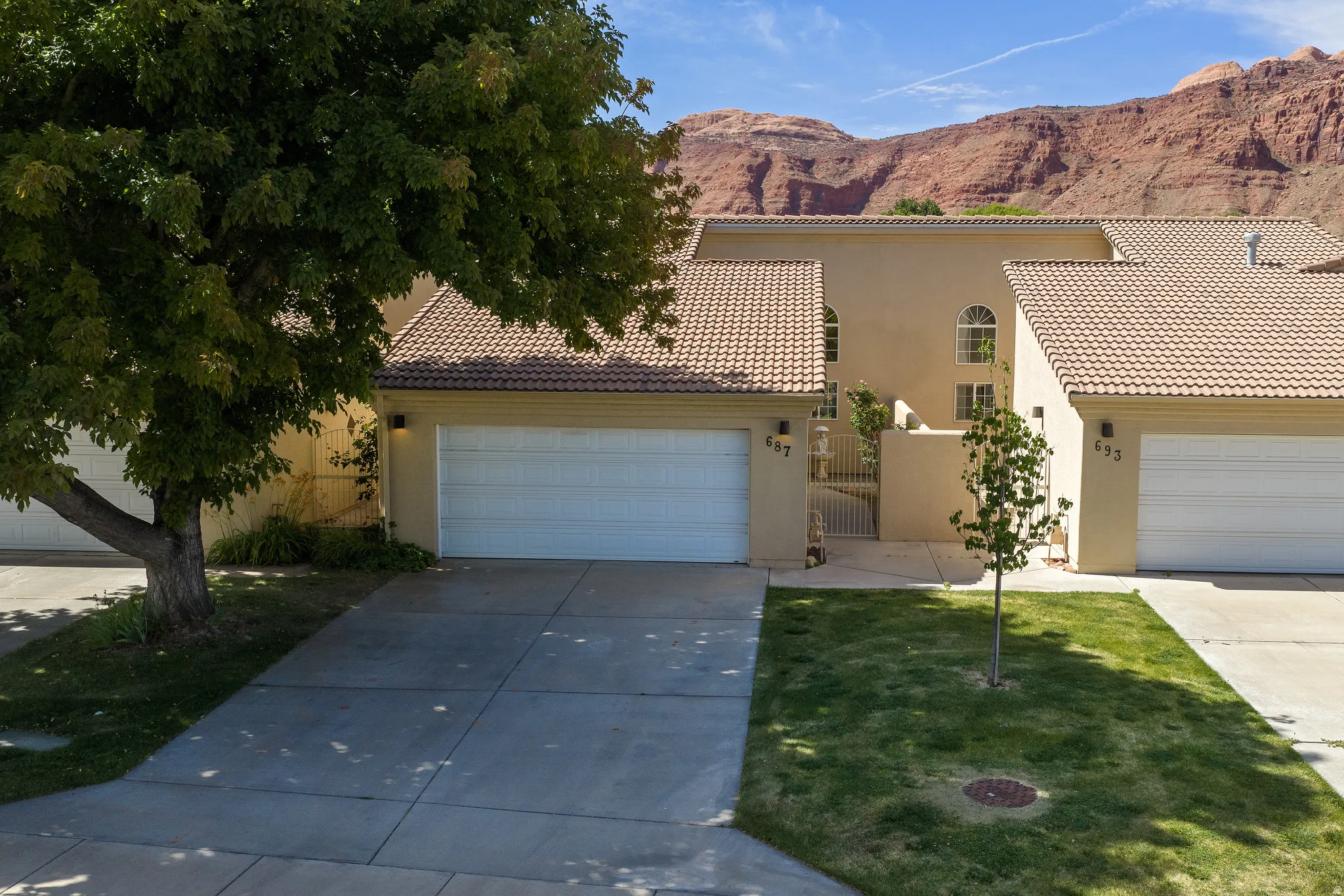 Southwestern-style residence featuring a stucco exterior and tiled roofing