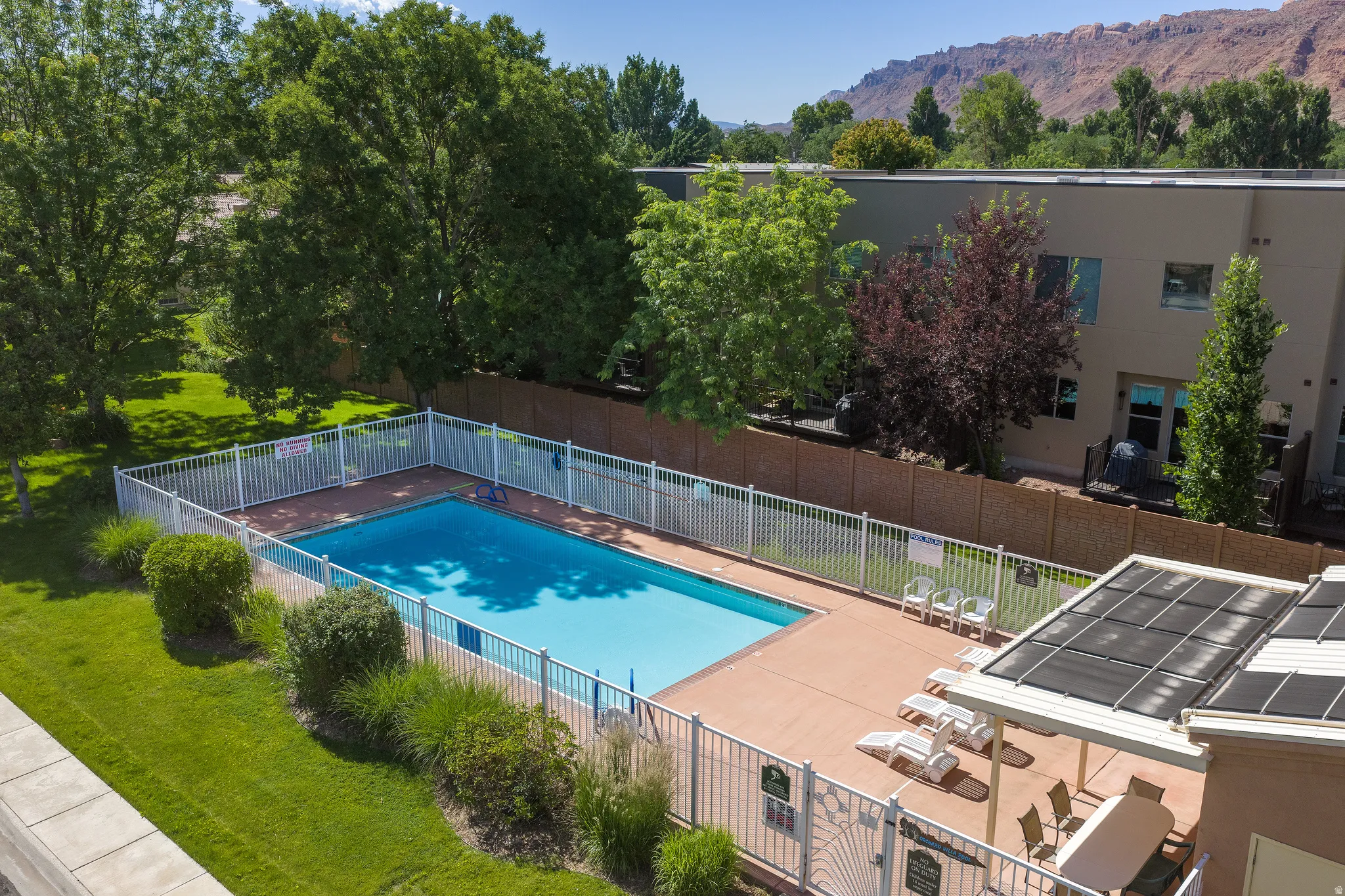 Rectangular outdoor swimming pool with surrounding patio decking