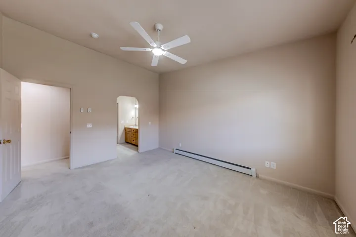 Spacious room with vaulted ceilings and a ceiling fan