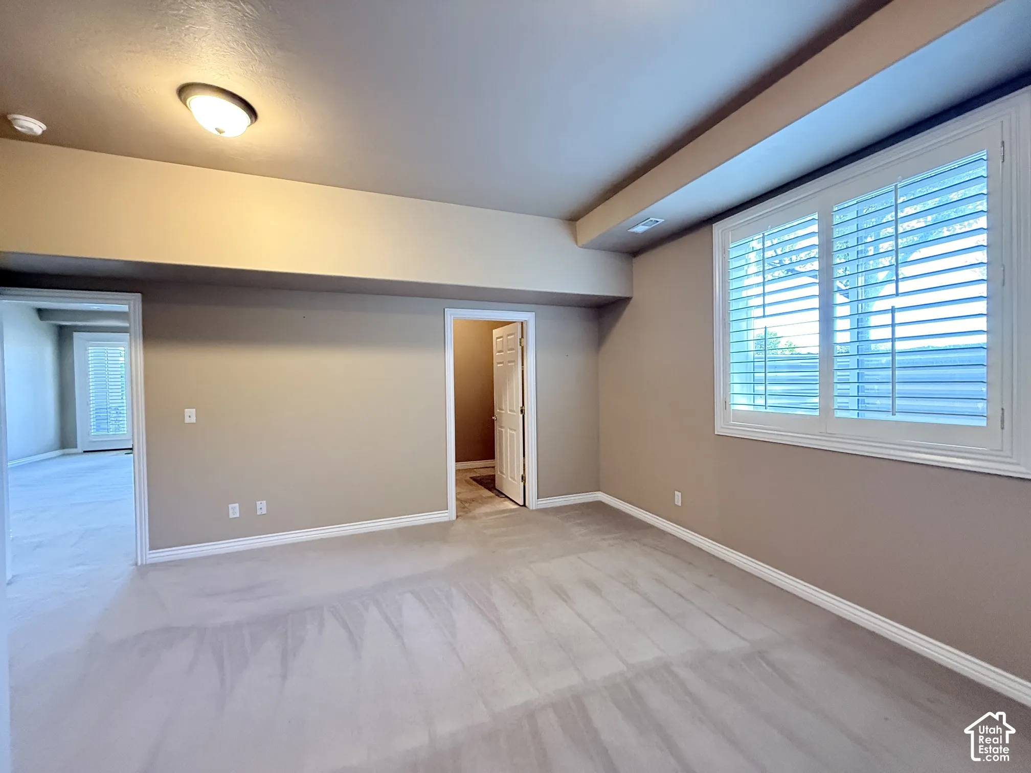 Neutral-toned wall paint and light-colored carpet flooring define this interior space