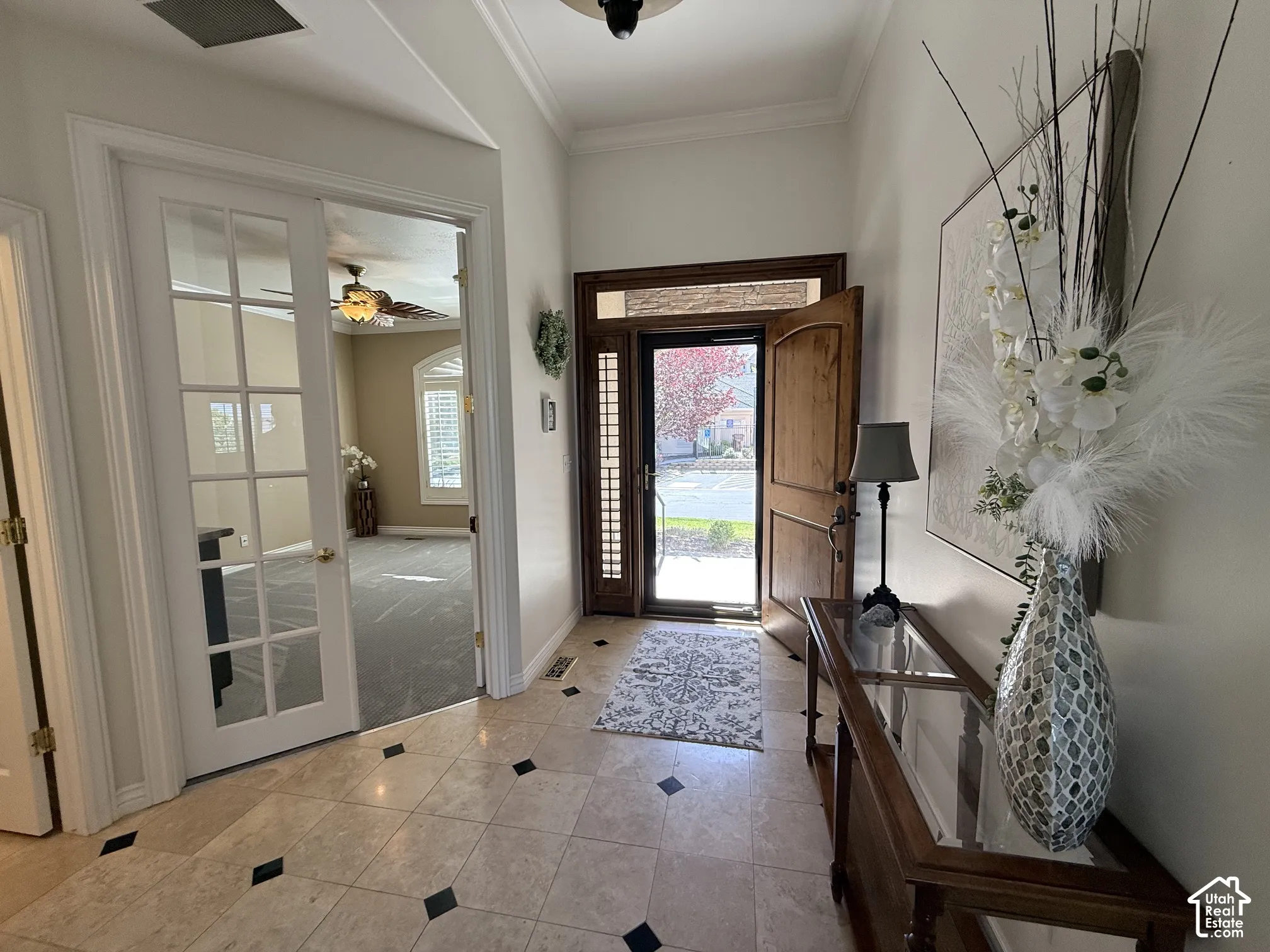 Entryway featuring light-toned tile flooring with dark accent squares