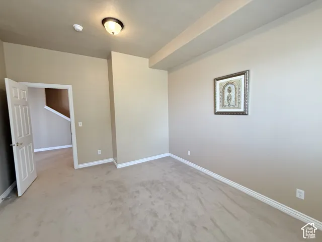 Recessed ceiling lighting, neutral tone carpeting, and classic white trim molding